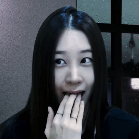 A Woman With A Ring On Her Finger Is Covering Her Mouth GIF