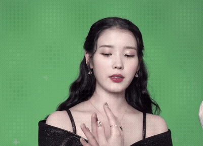 A Woman With A Ring On Her Finger Is Covering Her Mouth With Her Hands GIF