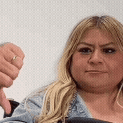 A Woman With A Ring On Her Finger Is Giving A Thumbs Down GIF