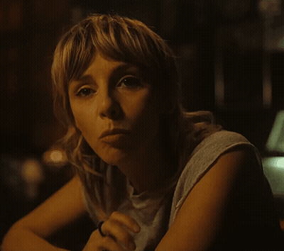 A Woman With A Ring On Her Finger Is Looking At The Camera GIF