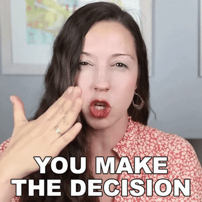 A Woman With A Ring On Her Finger Is Making A Gesture That Says You Make The Decision GIF