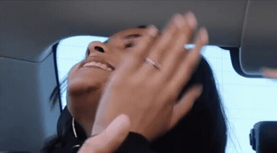 A Woman With A Ring On Her Finger Is Smiling And Clapping GIF