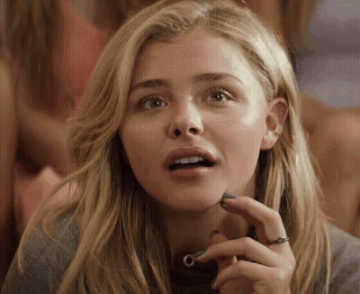 A Woman With A Ring On Her Finger Looks Surprised GIF