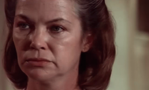 A Woman With A Sad Look On Her Face GIF