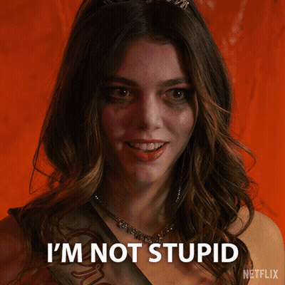 A Woman With A Sash Around Her Neck Says I 'M Not Stupid GIF