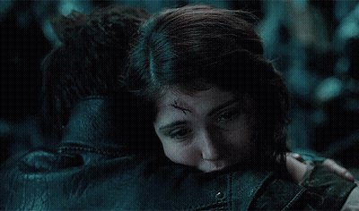A Woman With A Scar On Her Forehead Is Hugging A Man In A Leather Jacket GIF