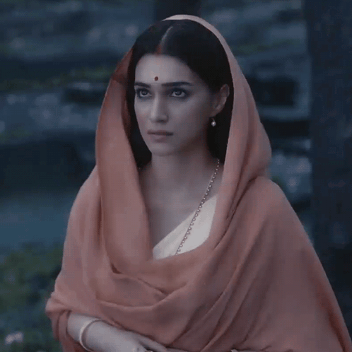 A Woman With A Scarf Around Her Head Has A Red Dot On Her Cheek GIF
