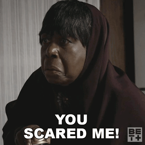 A Woman With A Scarf Around Her Head Says " You Scared Me " GIF