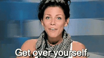 A Woman With A Scarf Around Her Neck Is Saying Get Over Yourself . GIF