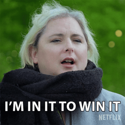 A Woman With A Scarf Around Her Neck Is Saying I 'M In It To Win It GIF