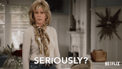 A Woman With A Scarf Around Her Neck Is Saying Seriously GIF