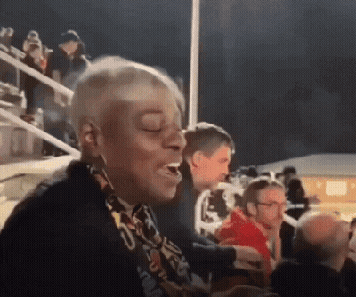 A Woman With A Scarf Around Her Neck That Says ' U.s.a. ' GIF
