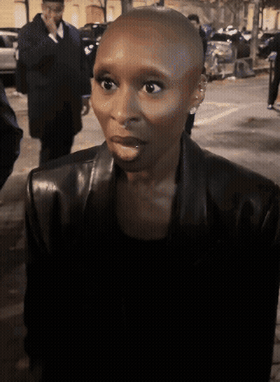 A Woman With A Shaved Head Is Wearing A Leather Jacket GIF