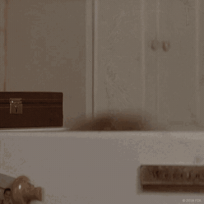 A Woman With A Shaving Cream Mask On Her Face Is Saying Hello GIF