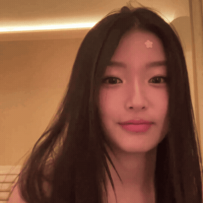 A Woman With A Star On Her Forehead Looks At The Camera GIF