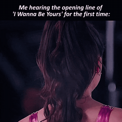 A Woman With A Star Shaped Earring On Her Left Ear Looks At The Camera GIF