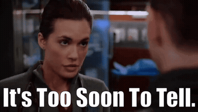 A Woman With A Stethoscope On Her Neck Is Talking To A Man . GIF