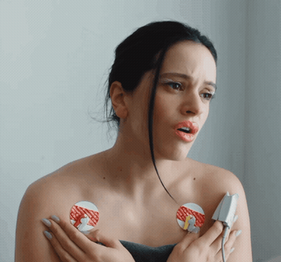 A Woman With A Sticker On Her Chest That Says ' I 'M Sorry ' GIF