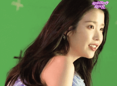 A Woman With A Strawberry Moon Logo On Her Face GIF