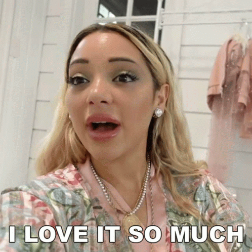 A Woman With A Surprised Look On Her Face And The Words I Love It So Much Below Her GIF