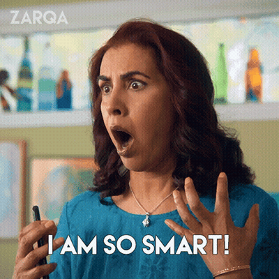 A Woman With A Surprised Look On Her Face Is Holding A Cell Phone And Says I Am So Smart GIF