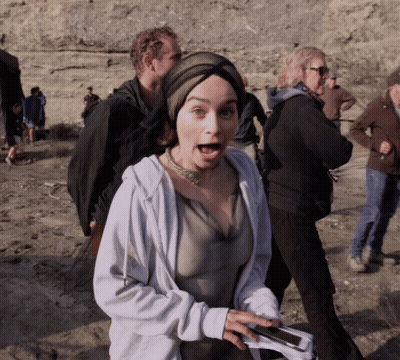 A Woman With A Surprised Look On Her Face Is Holding A Cellphone GIF