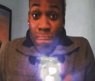 A Woman With A Surprised Look On Her Face Is Holding A Light GIF