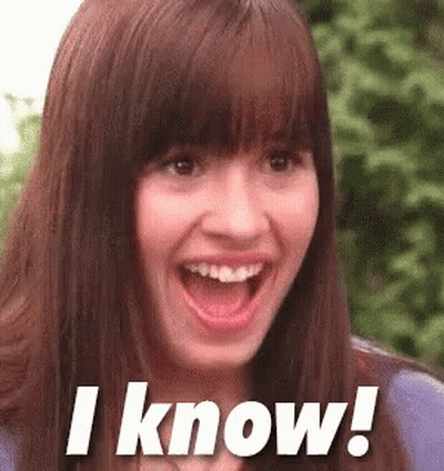A Woman With A Surprised Look On Her Face Is Smiling And Says I Know . GIF