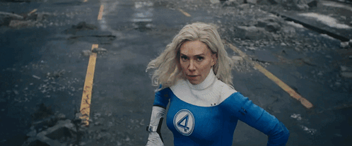 A Woman With A Surprised Look On Her Face Is Standing In Front Of A Painting . GIF