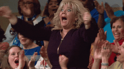 A Woman With A Surprised Look On Her Face Is Surrounded By Other People GIF