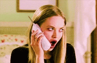 A Woman With A Surprised Look On Her Face Is Talking On A Cell Phone GIF