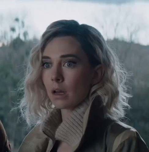 A Woman With A Surprised Look On Her Face Is Wearing A Jacket . GIF