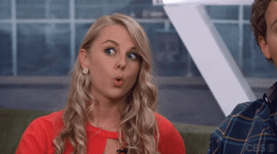 A Woman With A Surprised Look On Her Face Is Wearing A Red Top GIF