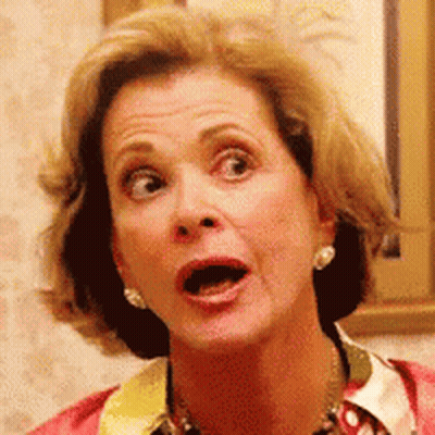 A Woman With A Surprised Look On Her Face Is Wearing Earrings . GIF