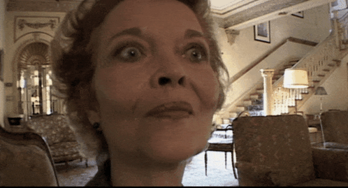 A Woman With A Surprised Look On Her Face Looks At The Camera GIF