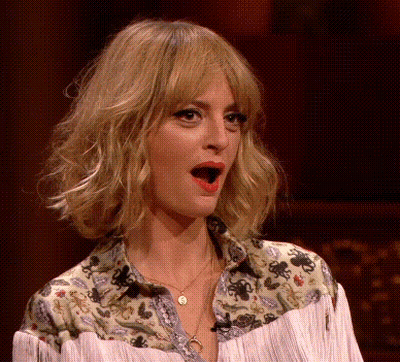 A Woman With A Surprised Look On Her Face Wearing A Fringed Shirt GIF