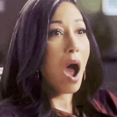 A Woman With A Surprised Look On Her Face . GIF