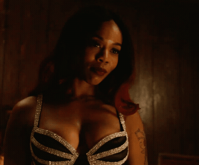 a woman with a tattoo on her arm has a bra on