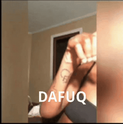 A Woman With A Tattoo On Her Arm Has The Word Dafuq On The Bottom Right GIF