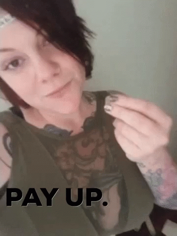 A Woman With A Tattoo On Her Arm Is Holding Something In Her Hand With The Words Pay Up Above Her GIF