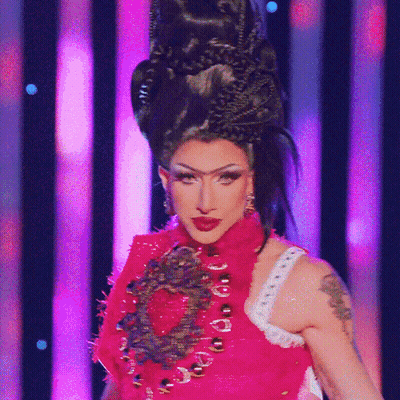 A Woman With A Tattoo On Her Arm Is Wearing A Red Dress GIF