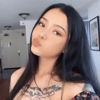 A Woman With A Tattoo On Her Chest That Says " I Love You " GIF