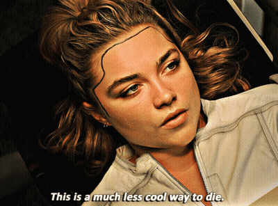 A Woman With A Tattoo On Her Forehead Is Laying Down And Says " This Is A Much Less Cool Way To Die " GIF