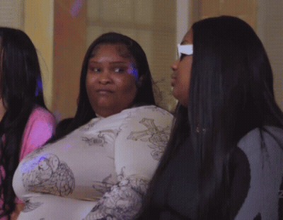 A Woman With A Tattoo On Her Forehead Looks At The Camera GIF