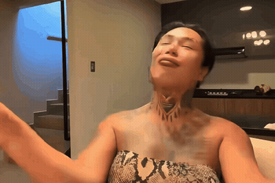 A Woman With A Tattoo On Her Neck Is Dancing GIF