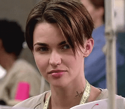 A Woman With A Tattoo On Her Neck Is Holding A Piece Of Paper . GIF