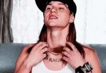 A Woman With A Tattoo On Her Neck That Says Rage GIF