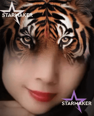 A Woman With A Tiger Face Painted On Her Face And The Word Starmaker On The Bottom GIF