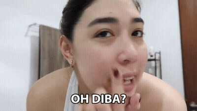 A Woman With A Towel Around Her Neck Is Looking At Her Face And Says Oh Diba ? GIF