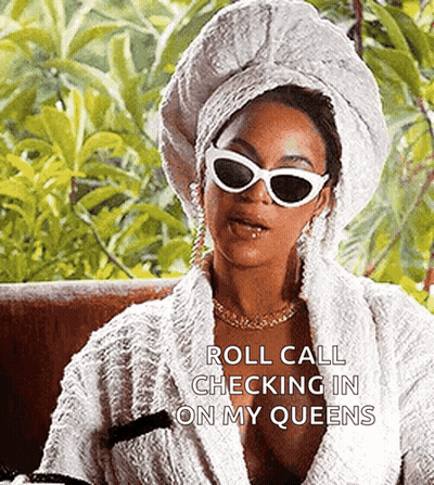 A Woman With A Towel Wrapped Around Her Head And Sunglasses Is Sitting On A Couch . GIF
